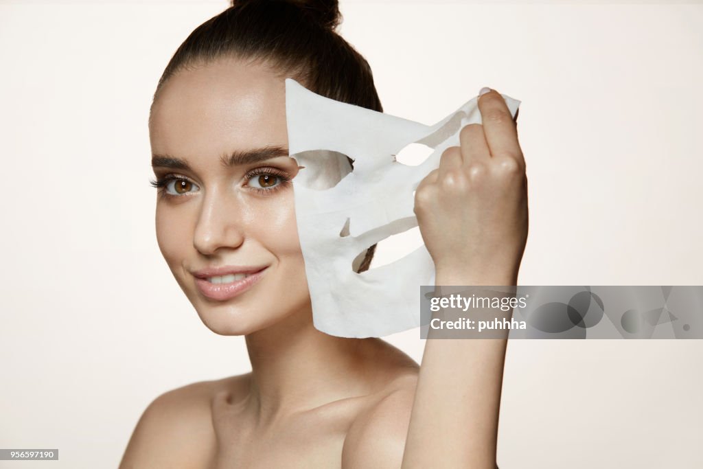 Woman Beauty Face. Young Female Removing Mask From Facial Skin