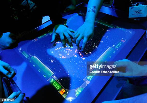 Attendees play a game on the Microsoft Surface multi-touch computer at the 2010 International Consumer Electronics Show at the Las Vegas Convention...
