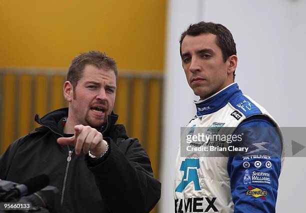 Driver Justin Wilson, right, talks to a crewman during Grand-Am Rolex Series testing on January 8, 2010 in Daytona Beach, Florida.