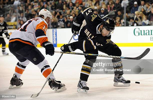 Defenseman Karlis Skrastins skates the puck past Nate Thompson of the New York Islanders in the second period on January 8, 2010 in Dallas, Texas.