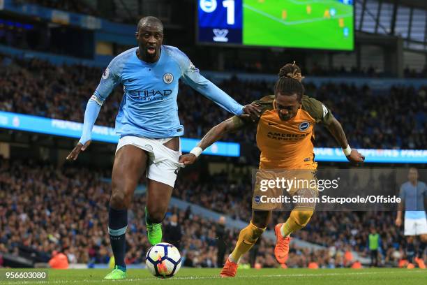 Gaetan Bong of Brighton pulls at the shorts of Yaya Toure of Man City during the Premier League match between Manchester City and Brighton & Hove...