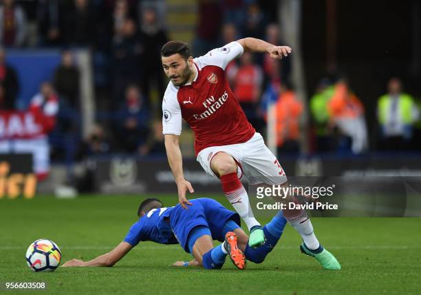 Sead Kolasinac of Arsenal rides the challenge from Riyad Mahrez of Leicester during the Premier League match between Leicester City and Arsenal at...