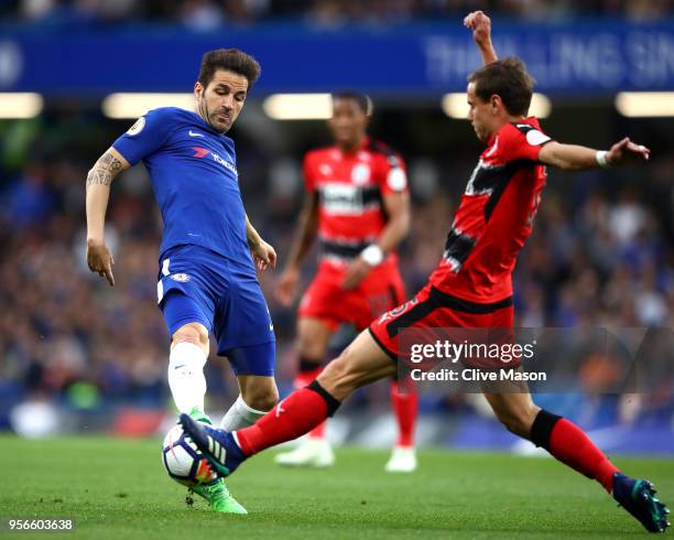 Cesc Fabregas of Chelsea is challenged by Chris Lowe of Huddersfield Town during the Premier League match between Chelsea and Huddersfield Town at...