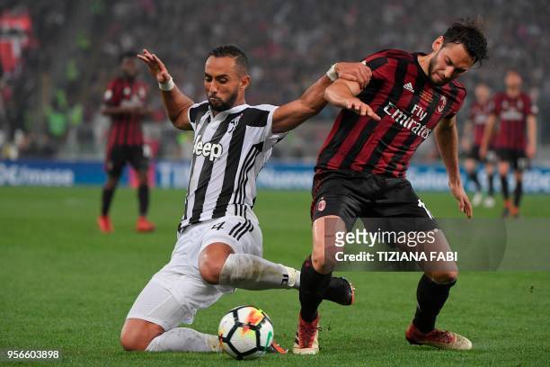 Milan's forward Hakan Calhanoglu vies with Juventus' defender from Italy Medhi Benatia during the Italian Tim Cup final Juventus vs AC Milan at the...