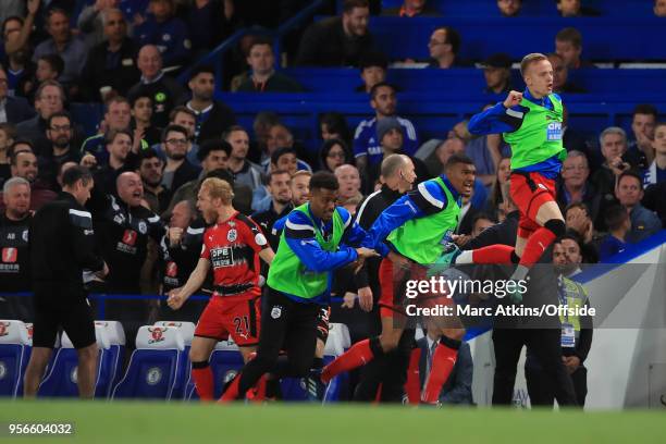 Huddersfield Town players celebrate own the bench during the Premier League match between Chelsea and Huddersfield Town at Stamford Bridge on May 9,...