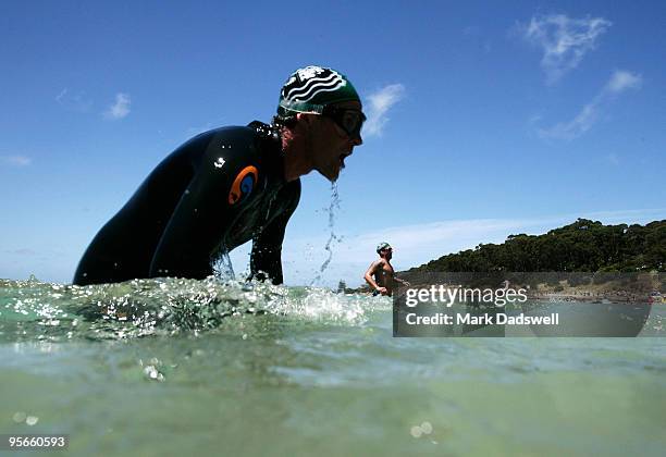 Competitor dives back into the water as he makes his way to the beach during the Lorne Pier to Pub at Main Beach Lorne on January 9, 2010 in Lorne,...