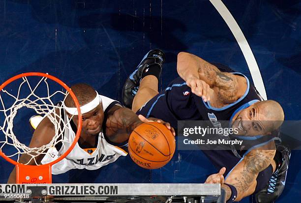 Zach Randolph of the Memphis Grizzlies fights for a rebound against Carlos Boozer of the Utah Jazz on January 8, 2010 at FedExForum in Memphis,...