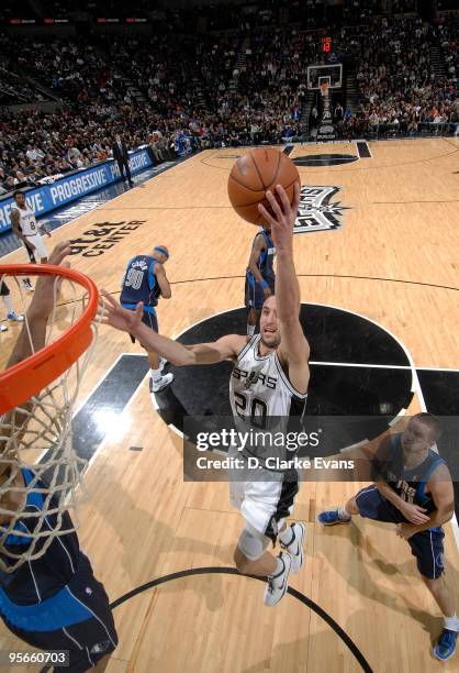 Manu Ginobili of the San Antonio Spurs dunks past Jose Juan Barea of the Dallas Mavericks on January 8, 2010 at the AT&T Center in San Antonio,...