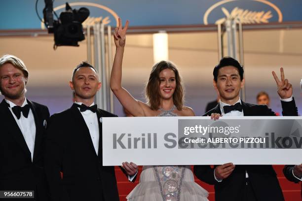 Russian producer Ilya Stewart, Russian actor Roma Zver, Russian actress Irina Starshenbaum and German actor Teo Yoo hold a cardboard bearing the name...