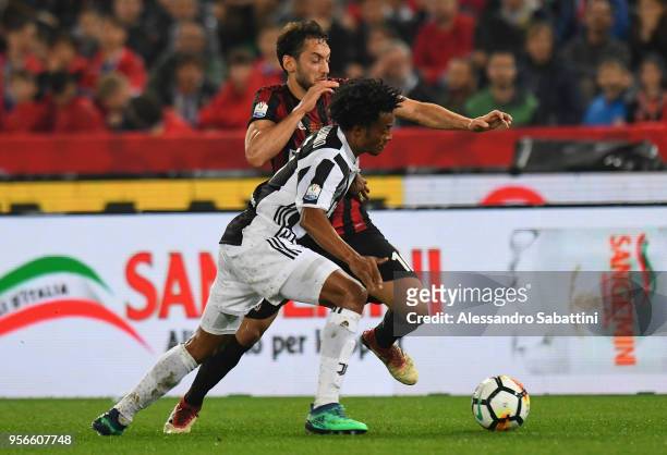 Bello Juan Cudrado of Juventus competes for the ball whit Hakan Calhanoglu of AC Milan during the TIM Cup Final between Juventus and AC Milan at...