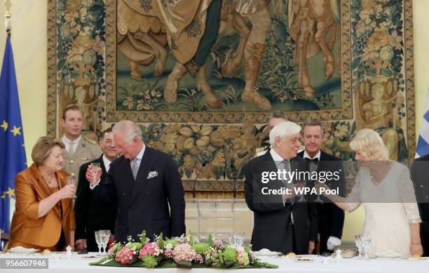 Vlassia Peltsemi-Pavlopoulous and Prince Charles, Prince of Wales and President of Greece Prokopis Pavlopoulos and Camilla, Duchess of Cornwall toast...