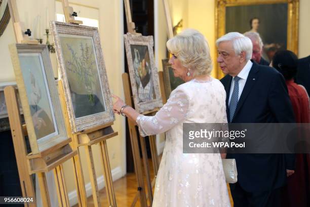 President of Greece Prokopis Pavlopoulos and Camilla, Duchess of Cornwall look at paintings during an Official Dinner at the Presidential Mansion on...