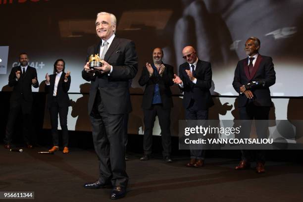 Director Martin Scorsese acknowledges applause from French directors Jacques Audiard , Cedric Klapisch after receiving from the French Association of...