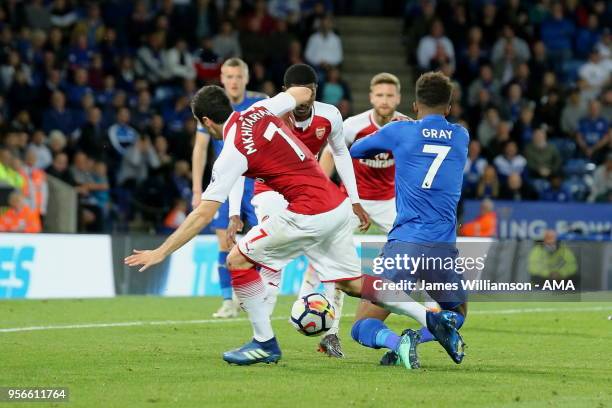 Henrikh Mkhitaryan of Arsenal brings down Demarai Gray of Leicester City in the penalty area during the Premier League match between Leicester City...