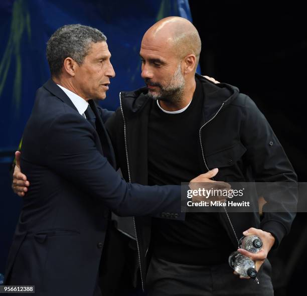 Chris Hughton, Manager of Brighton and Hove Albion embraces Josep Guardiola, Manager of Manchester City prior to the Premier League match between...