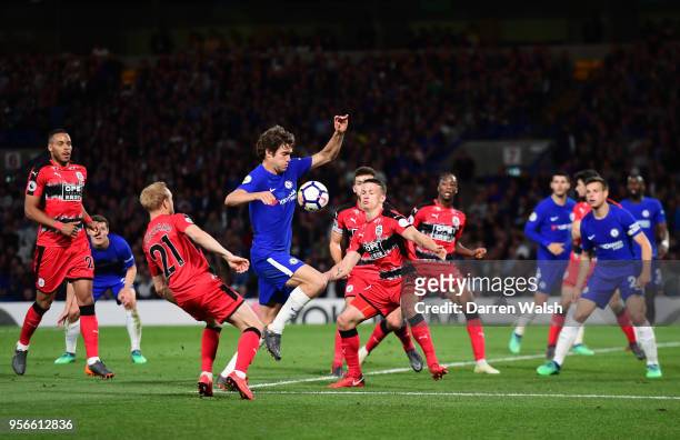 Marcos Alonso of Chelsea is challenged by Alex Pritchard of Huddersfield Town during the Premier League match between Chelsea and Huddersfield Town...
