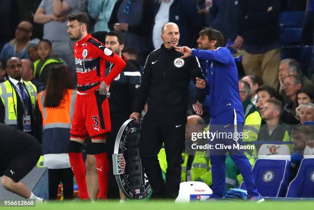 Antonio Conte, Manager of Chelsea argues with Mike Dean the fourth offical during the Premier League match between Chelsea and Huddersfield Town at...