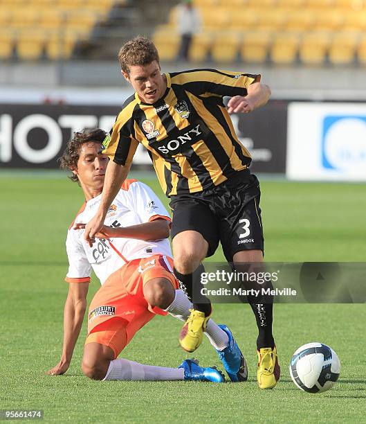 Tony Lochhead of the Phoenix is tackled by Adam Sarota of the Roar during the round 22 A-League match between the Wellington Phoenix and the Brisbane...