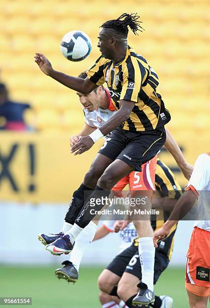 Eugene Dadi of the Phoenix jumps for the ball with Josh McCloughan of the Roar during the round 22 A-League match between the Wellington Phoenix and...
