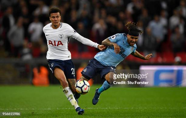 Dele Alli of Tottenham Hotspur battles for possession with Deandre Yedlin of Newcastle United during the Premier League match between Tottenham...