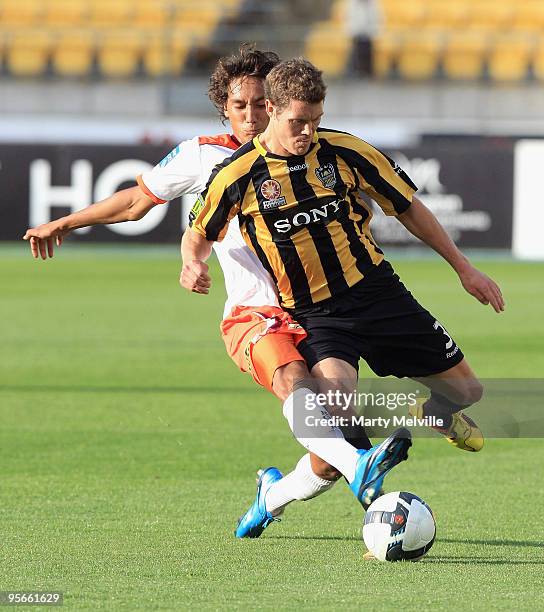 Tony Brown of the Phoenix is tackled by Adam Sarota of the Roar during the round 22 A-League match between the Wellington Phoenix and the Brisbane...