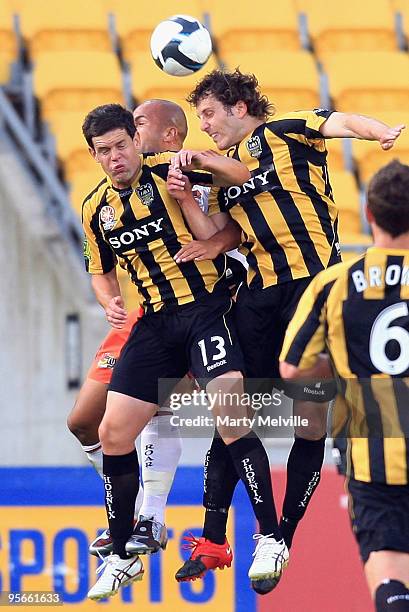 Troy Hearfield and Jonathan McKain of the Phoenix jump for the ball with Sergio; Van Dijk of the Roar during the round 22 A-League match between the...