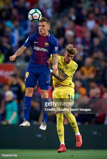 Lucas Digne of Barcelona competes for the ball with Samuel Castillejo of Villerral during the La Liga match between Barcelona and Villarreal at Camp...