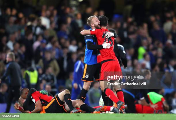 The Huddersfield Town team celebart avoiding relegation after the Premier League match between Chelsea and Huddersfield Town at Stamford Bridge on...