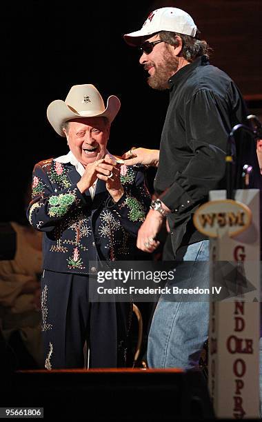 Country singer Little Jimmy Dickens greets singer Hank Williams Jr. As he leaves the stage at the Sprint Sound & Speed concert at Ryman Auditorium on...