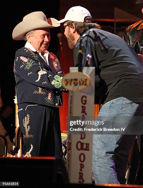 Country singer Little Jimmy Dickens greets singer Hank Williams Jr. As he leaves the stage at the Sprint Sound & Speed concert at Ryman Auditorium on...