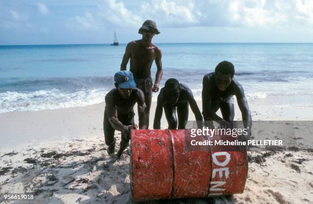 Récupération de marchandise échouée sur la plage en juillet 1979 aux Seychelles.