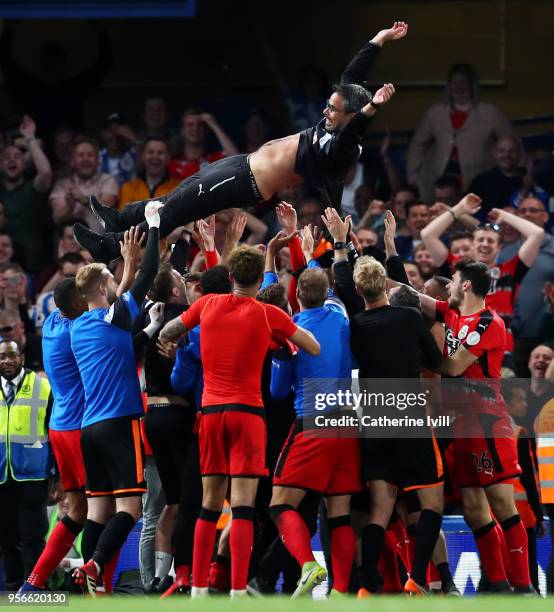 David Wagner, Manager of Huddersfield Town is throw into the air in celebration as his team avoid relegation after the Premier League match between...