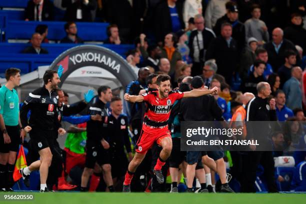 Huddersfield Town's English defender Tommy Smith runs onto the pitch to celebrate at the final whistle during the English Premier League football...