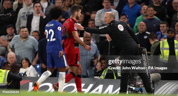 Chelsea's Willian and fourth official Mike Dean usher Huddersfield Town's Tommy Smith off the pitch as he is substituted during the Premier League...