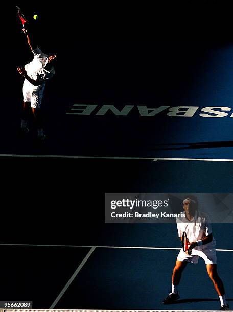 Marc Gicquel of France playing with Jeremy Chardy of France serves in his mens doubles semi-final match against Andy Roddick of the USA and James...