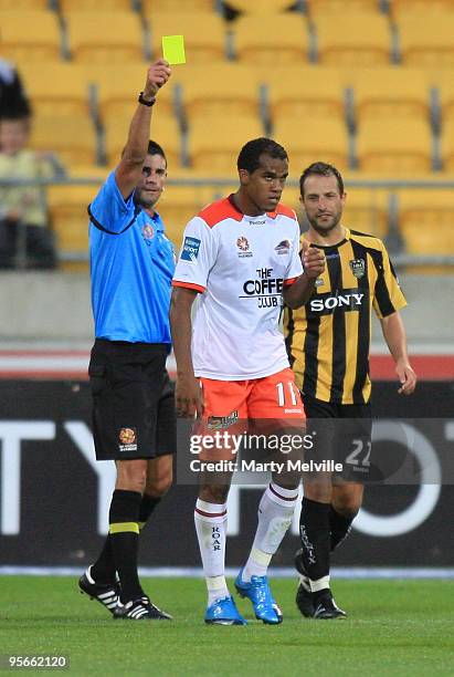 Reinaldo of the Roar is shown a yellow card during the round 22 A-League match between the Wellington Phoenix and the Brisbane Roar at Westpac...