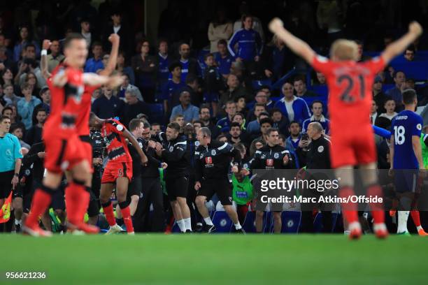 Huddersfield Town players and coaching staff react as they secure safety in the Premier League during the Premier League match between Chelsea and...