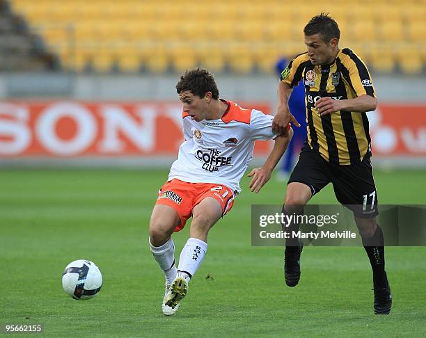 Tommy Oar of the Roar is tackled by Vince Lia of the Phoenix during the round 22 A-League match between the Wellington Phoenix and the Brisbane Roar...