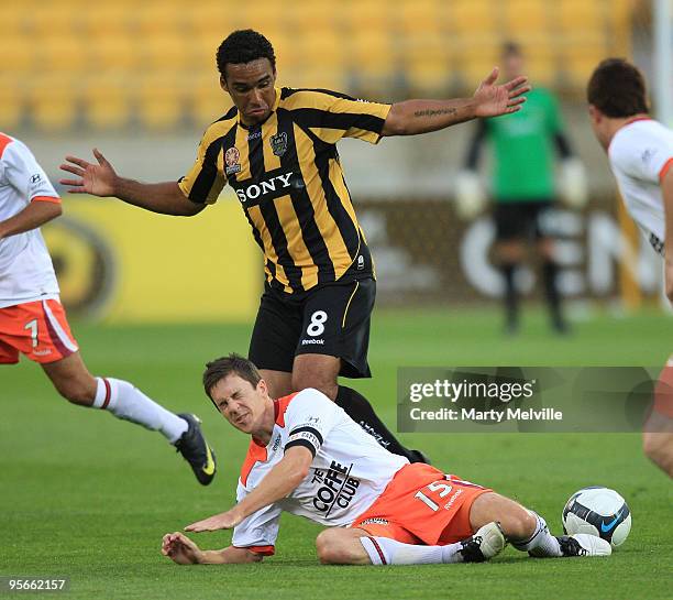 Paul Ifill of the Phoenix looks down at Matt McKay captain of the Roar during the round 22 A-League match between the Wellington Phoenix and the...