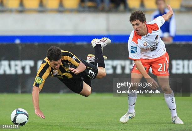 Troy Hearfield of the Phoenix is tripped by Tommy Oar of the Roar during the round 22 A-League match between the Wellington Phoenix and the Brisbane...