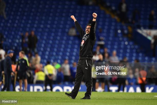 Huddersfield Town's German head coach David Wagner gestures to the fans as he celebrates after the final whistle during the English Premier League...