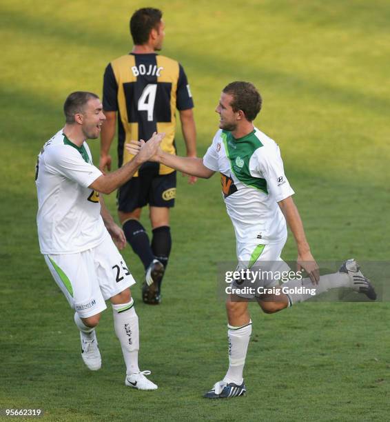 Jeremy Brockie of the Fury celebrates with team mate Grant Smith after scoring during the round 22 A-league match between the Central Coast Mariners...