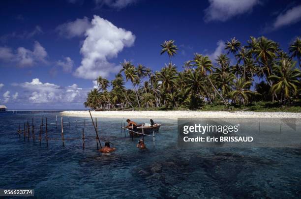 Pêcheurs au bord d'une plage en 1984 en Polynésie française.