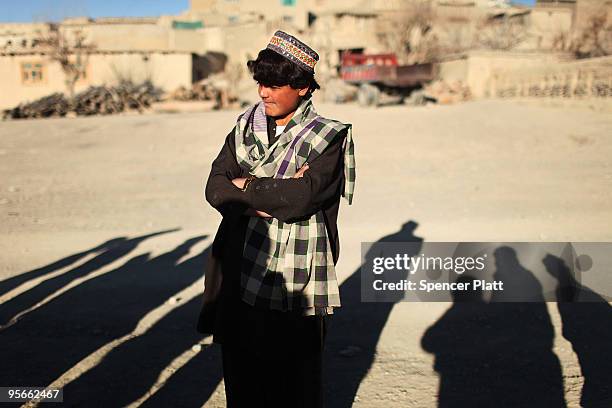 Teenager listens to members of a US Army Provincial Reconstruction Team on January 9, 2010 in Pushtay, Afghanistan. The soldiers, from Forward...