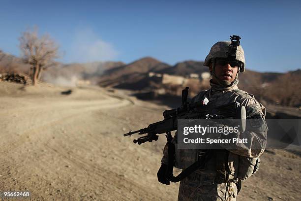 Army soldier Mitchel Brannon, a member of a Provincial Reconstruction Team and from Phoenix, Arizona, keeps watch on a distant mountain during a...