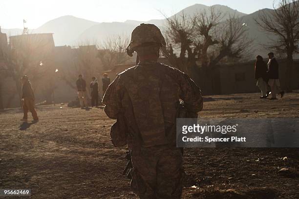 Army soldiers with a Provincial Reconstruction Team enter the village of Pushtay January 9, 2010 in Pushtay, Afghanistan. Soldiers, from Forward...