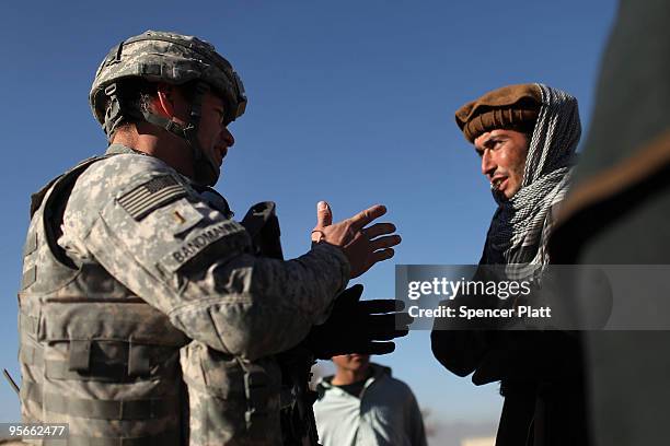 Kimo Bandmann of Utah with the 405 Civil Affairs Unit and part of a Provincial Reconstruction Team ,speaks with residents during a visit to the...