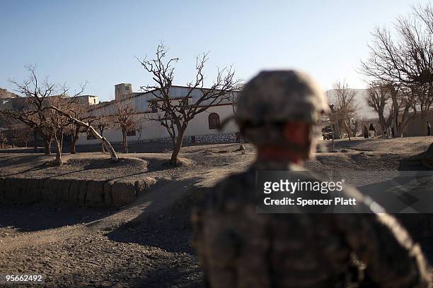 Army soldiers with a Provincial Reconstruction Team enter the village of Pushtay January 9, 2010 in Pushtay, Afghanistan. Soldiers, from Forward...