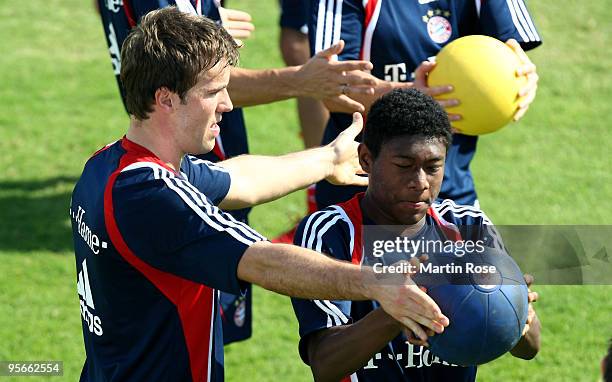 Michael Rensing of Bayern Muenchen and David Alaba in action during the FC Bayern Muenchen training session at the Al Nasr training ground on January...