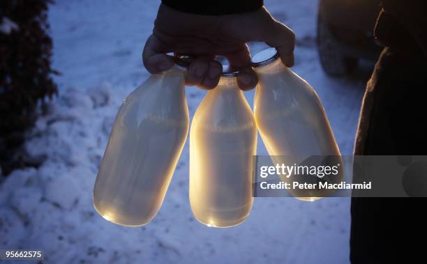 Milkman Guy Whittaker delivers milk in the snow on January 9, 2010 in Guildford, England. The United Kingdom continues to suffer from extreme cold...